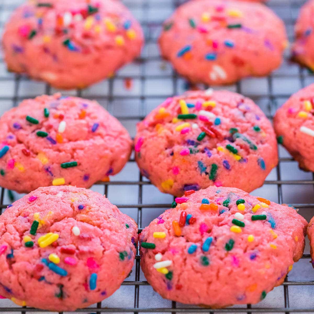 Strawberry Funfetti Cookies on a wire cooling rack.