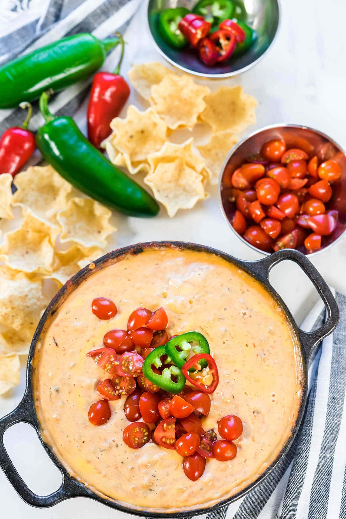 Cast Iron skillet filled with Velveeta Cheese Dip, topped with diced tomatoes and jalapeños. Served with tortilla chips.