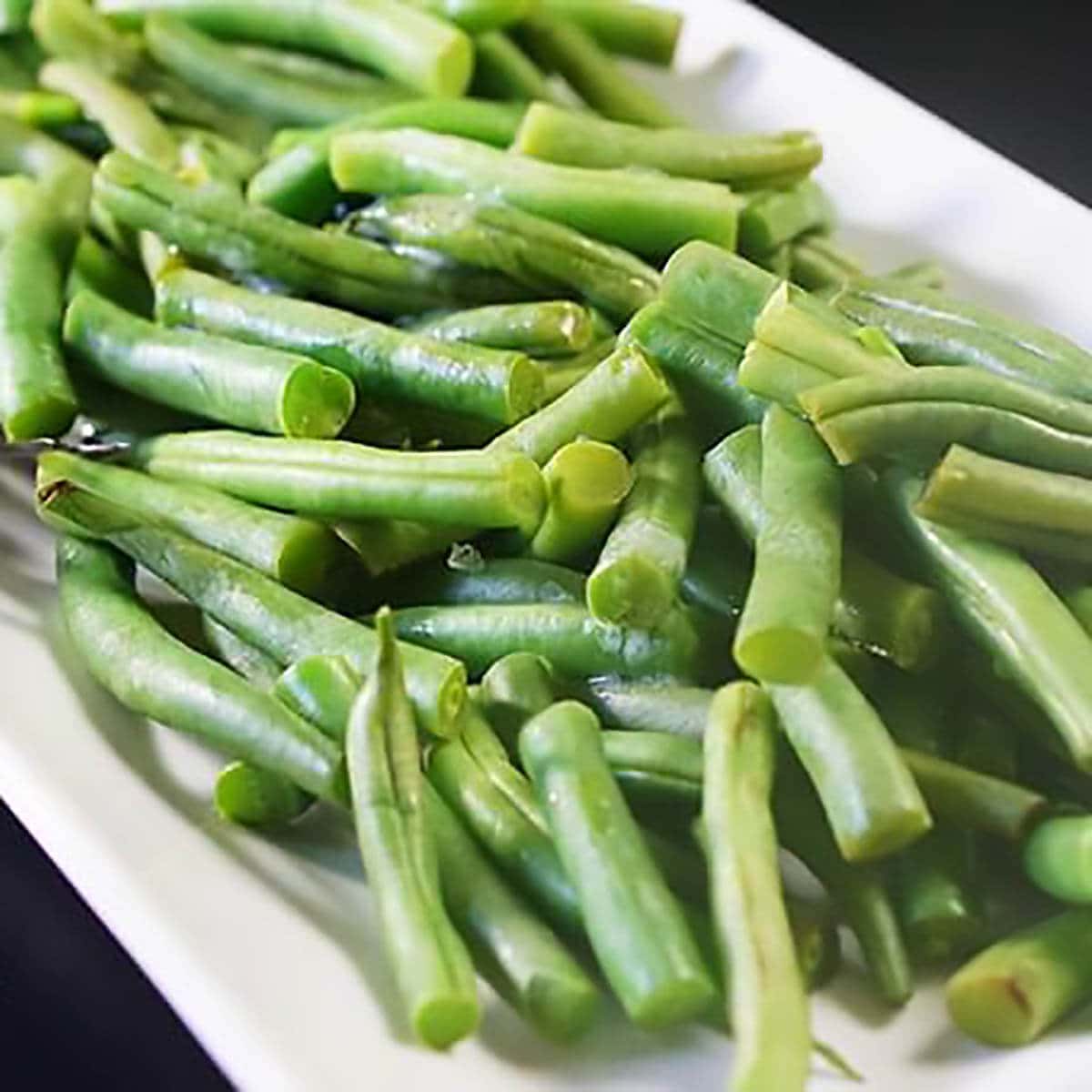 Steamed Green Beans on a white platter