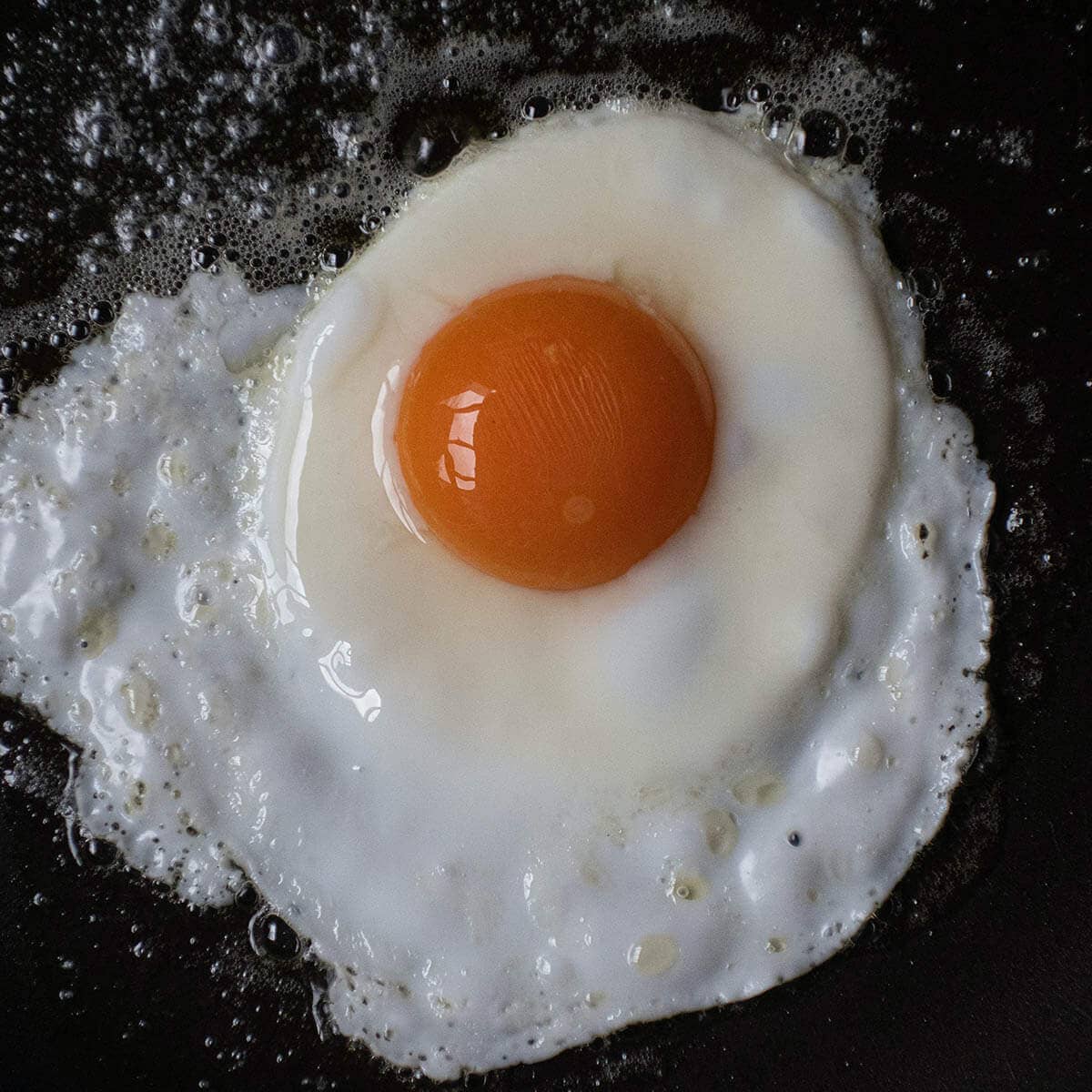 fried egg sunny side up in fry pan.