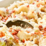 Mashed potatoes in casserole dish topped with bacon, with print overlay.