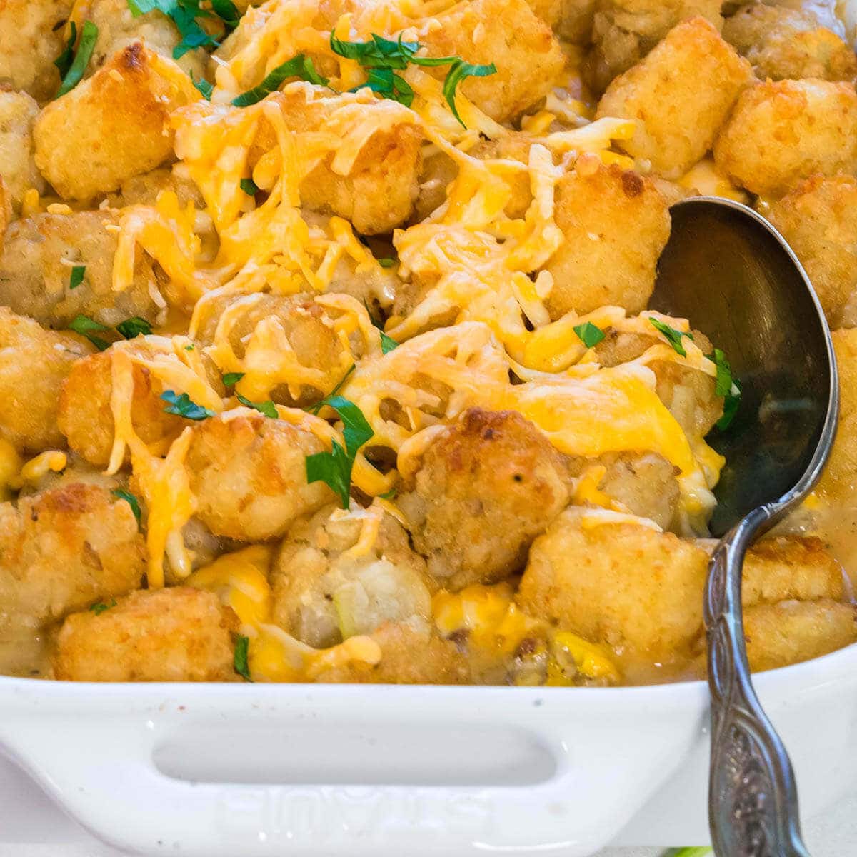 Cowboy Casserole in white dish with serving spoon.