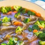 Glass noodle soup in with vegetable in blue pot with Pinterest overlay.