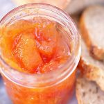 Papaya Jam in jar with bread on the side.