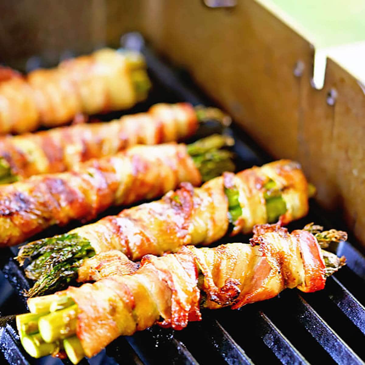 Cooked bacon wrapped asparagus on the grill.