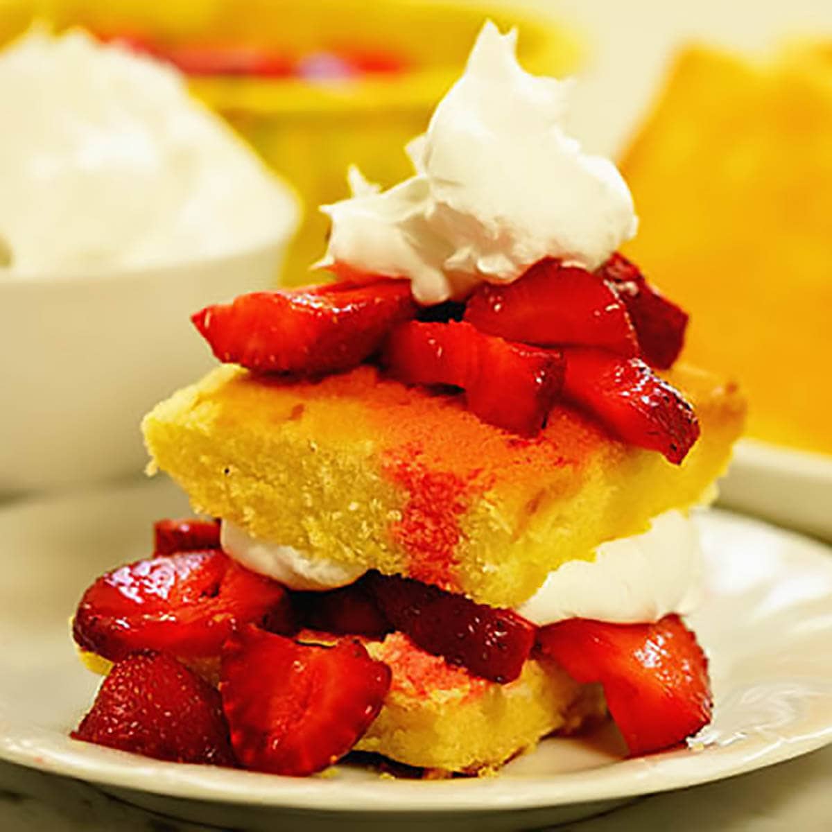 Shortcake layered with strawberries and whipped cream.