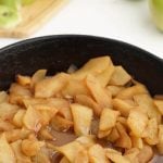 Fried apples in cast iron skillet with Pinterest overlay.