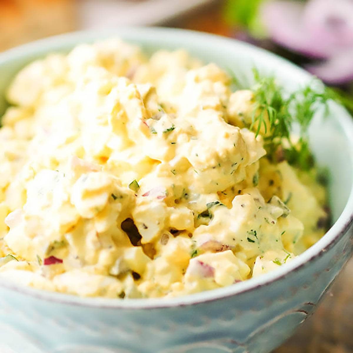 Egg Salad Spread in bowl garnished with dill.