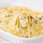Baked Chicken Tetrazzini in casserole dish with spoon.