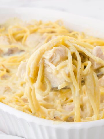 Baked Chicken Tetrazzini in casserole dish with spoon.