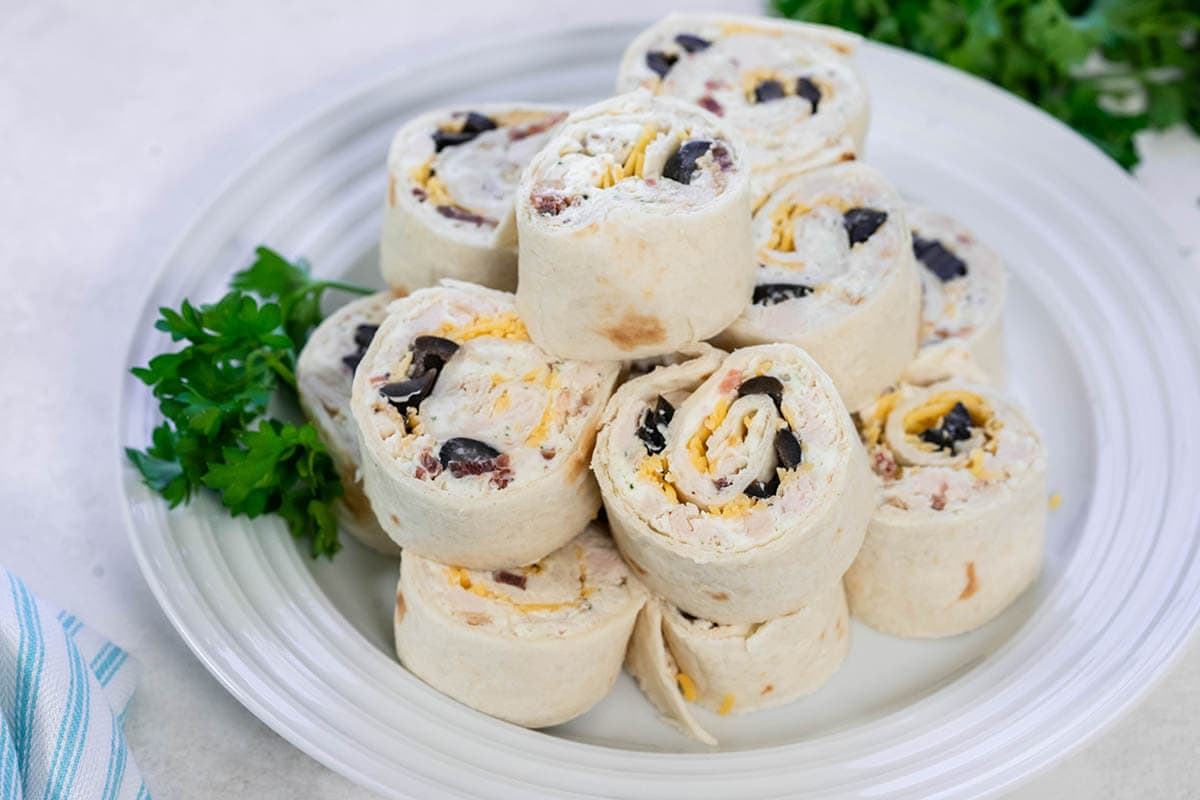 Tortilla roll-ups on white plate.