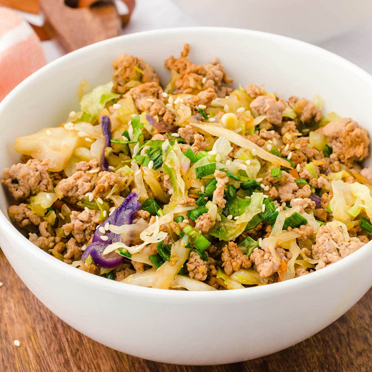 Bowl filled with sausage cabbage Asian stir fry.