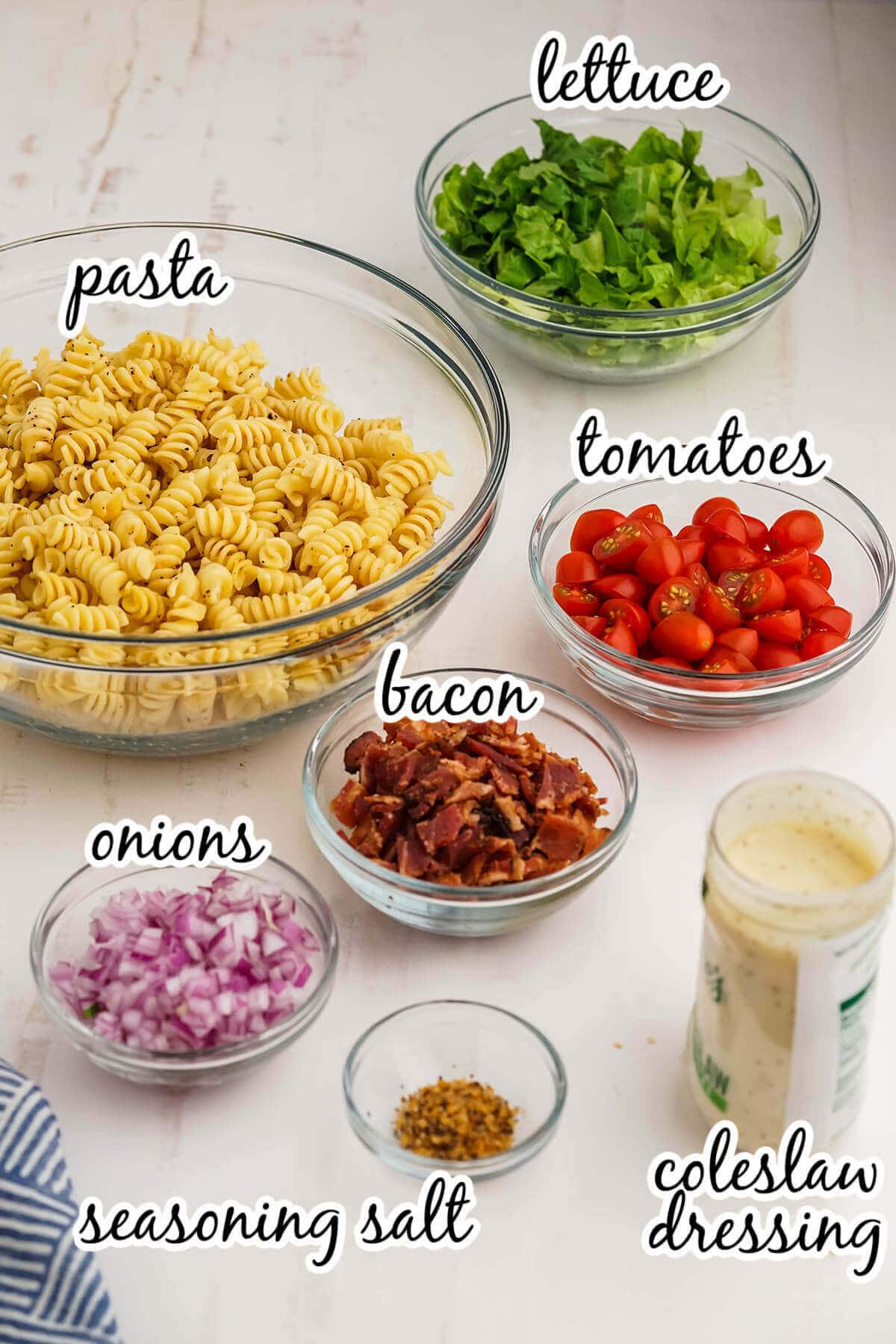 Ingredients needed to make pasta salad recipe. With print overlay.