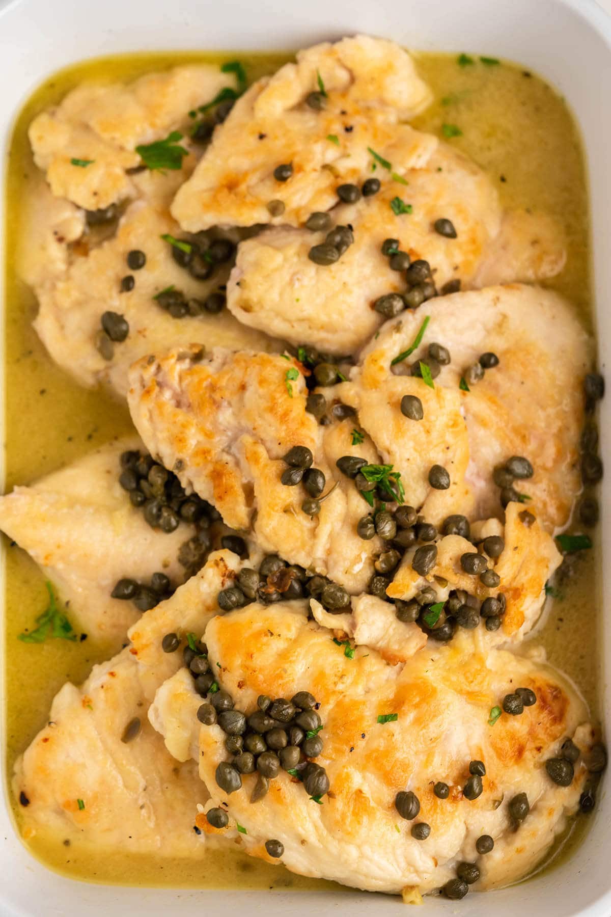 Baked CPK Chicken Piccata in casserole dish.