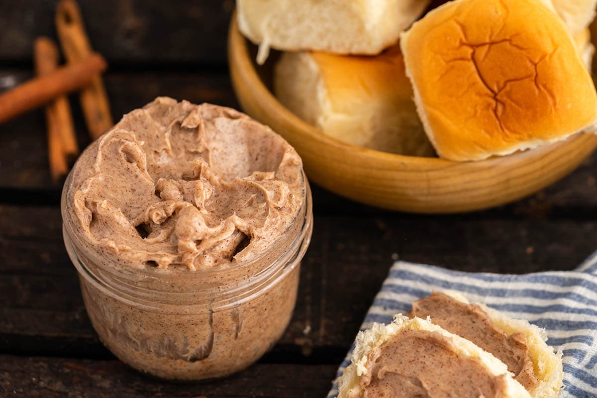 Compound butter in small jar with rolls.