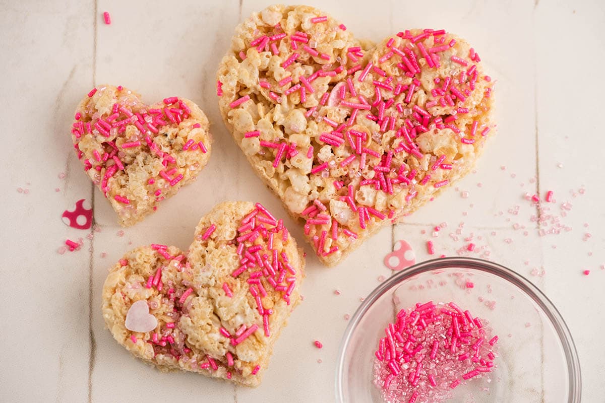 Crispy cereal treats covered with pink sprinkles for Valentine's Day.
