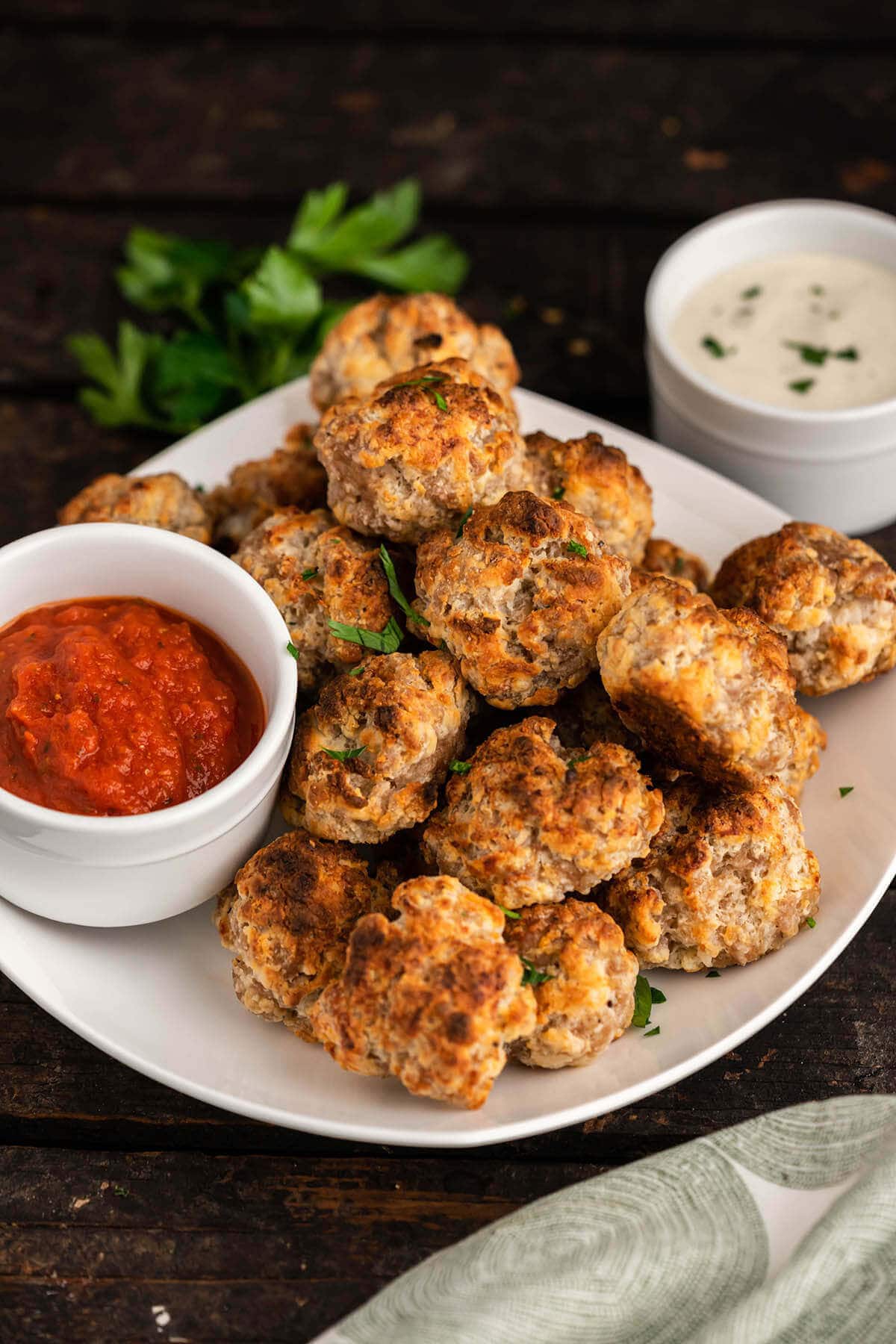Meatball appetizers on platter served with two dipping sauces.