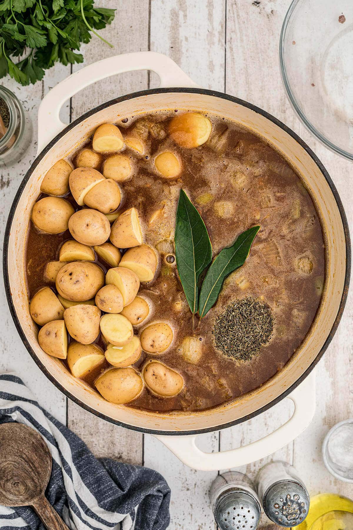 Stockpot filled with stew and vegetables. Potatoes were just added along with two bay leaves. 