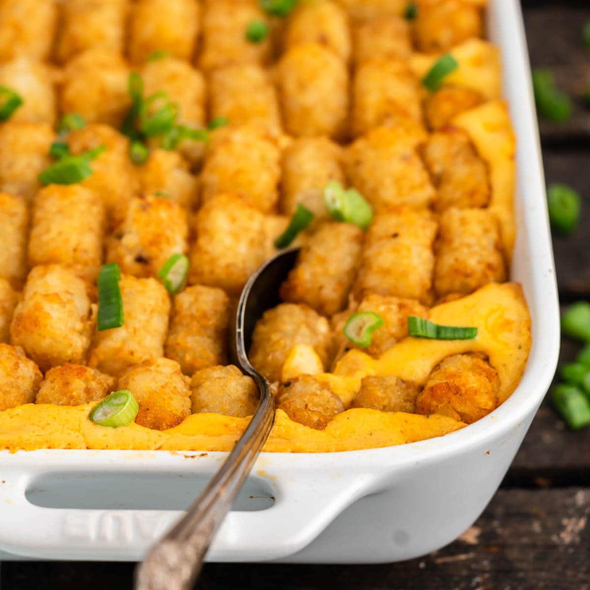 Tater Tot Casserole with serving spoon.