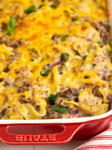 Pasta casserole in baking dish topped with cheese.