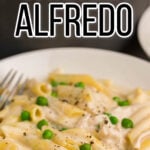 Creamy pasta in bowl with fork. With Pinterest overlay.
