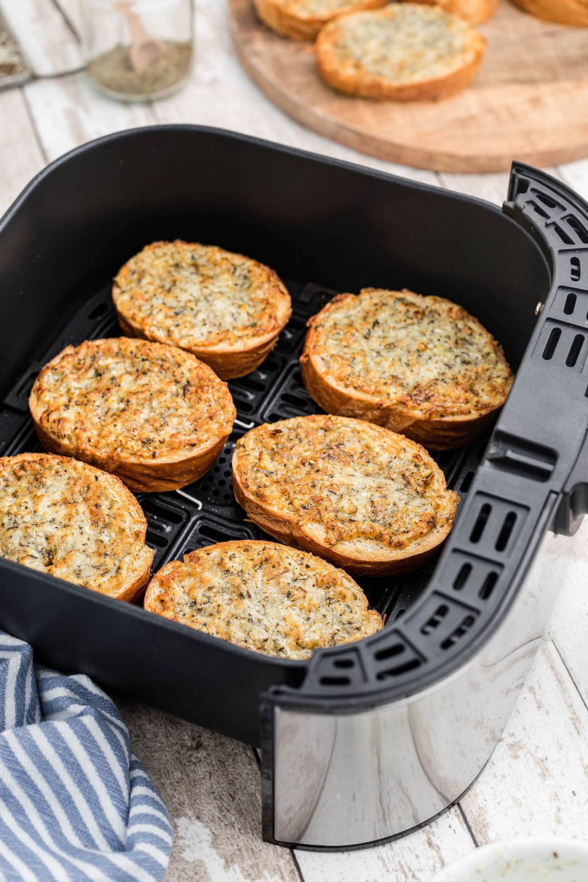 Toasted bread in air fryer basket. 