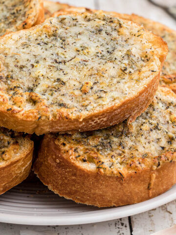 Crispy garlic bread on piled. on plate.