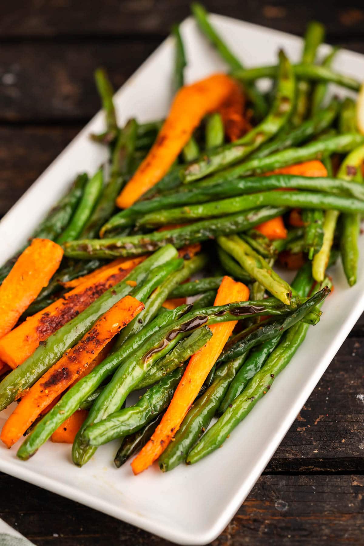 Roasted Green Beans and Carrots on white platter.