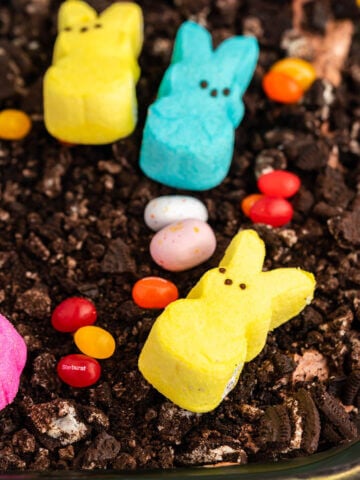 Easter Dirt Cake decorated with candy eggs and bunny peeps.