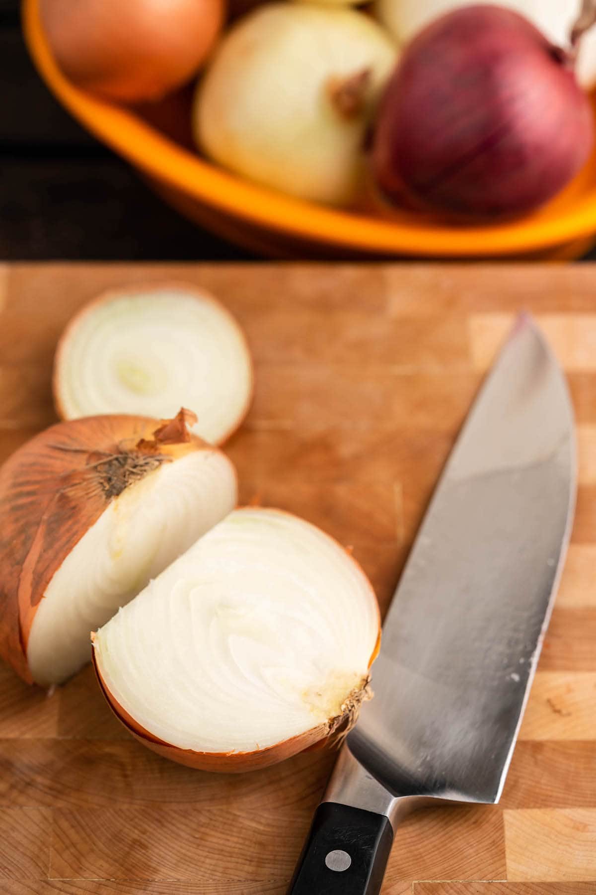 Onion on cutting board sliced in half.