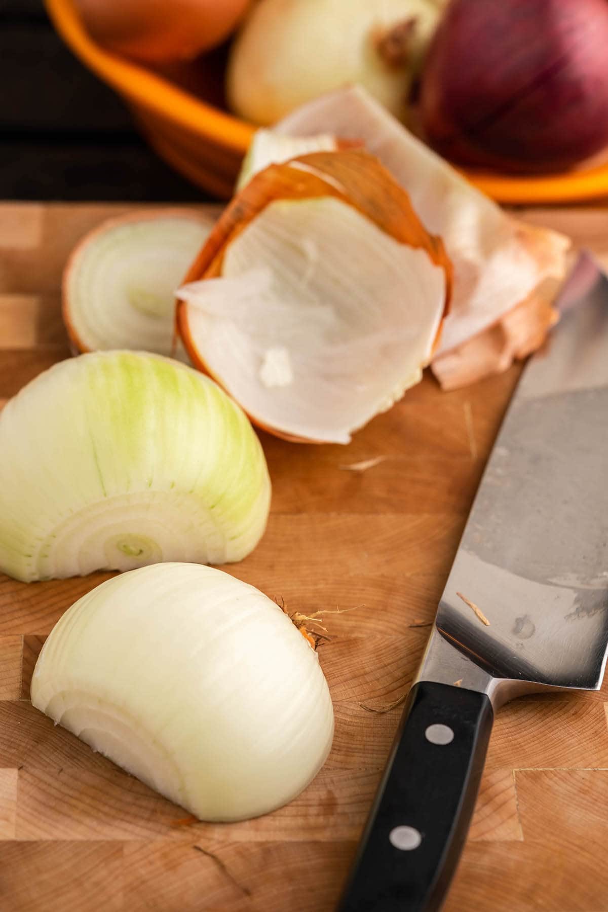 An onion that's been sliced in half and peeled.