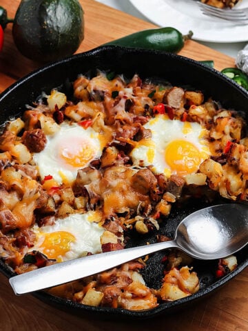 Mexican Breakfast with potatoes and eggs in cast iron skilet.