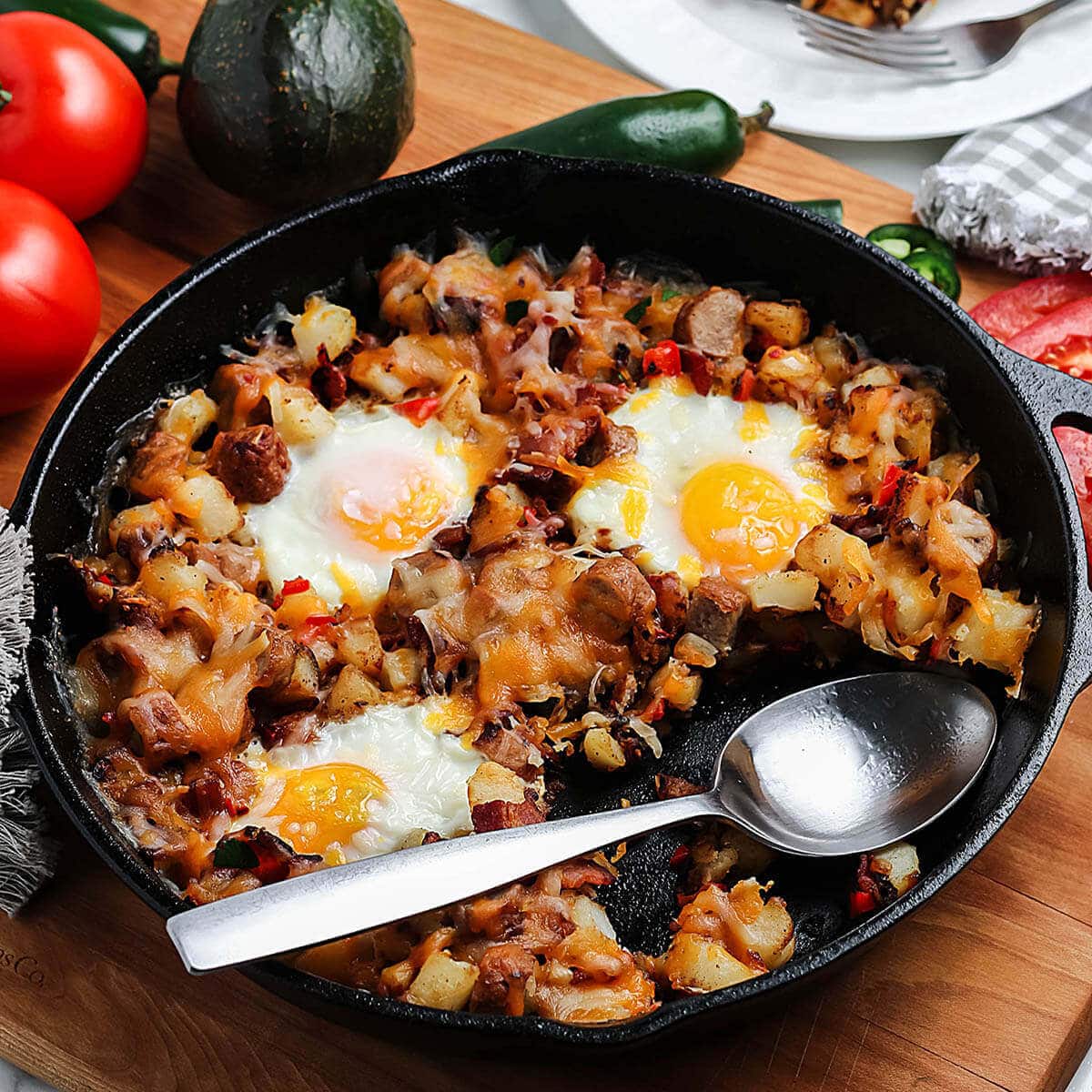 Mexicaan Breakfast with potatoes and eggs in cast iron skilet.