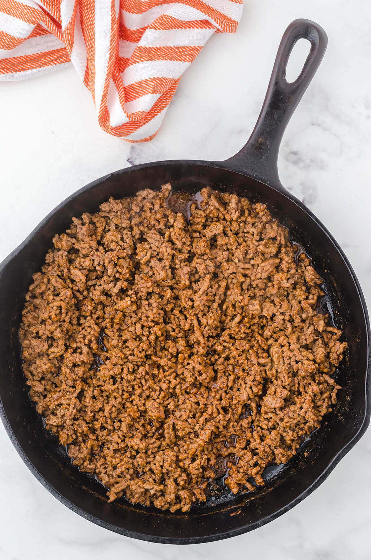 Cooked ground beef taco meat in a cast iron skillet. 