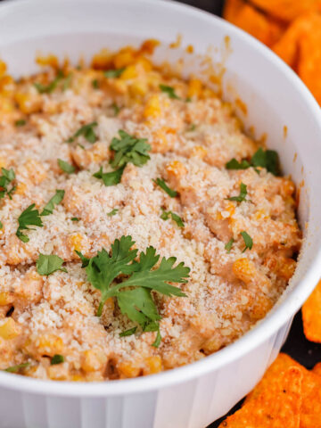 Mexican corn casserole recipe in baking dish with chips.