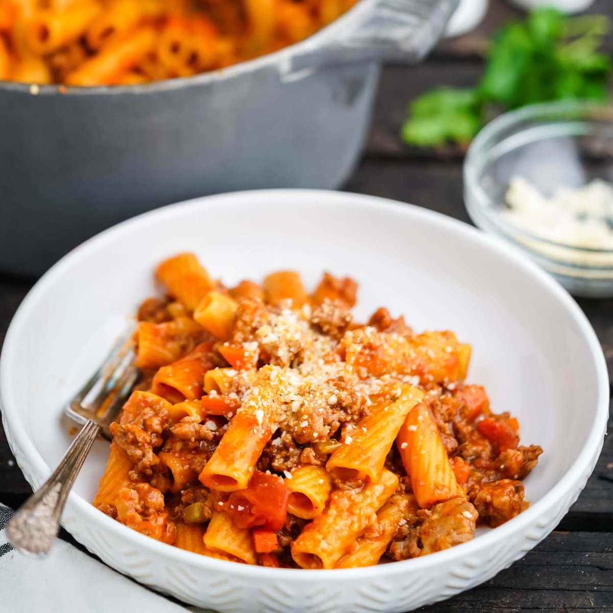 Rigatoni Bolognese in bowl with fork.