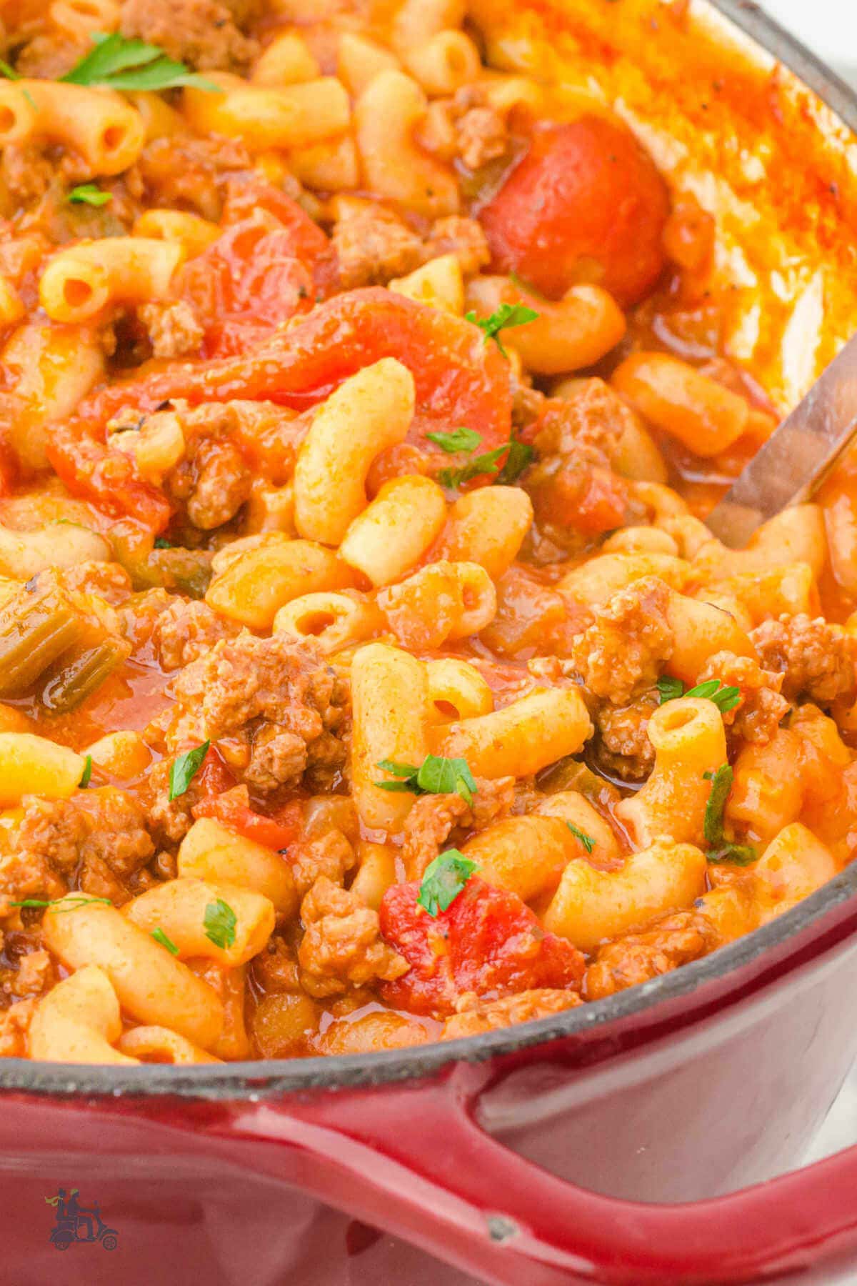 Goulash in pot with serving spoon. 