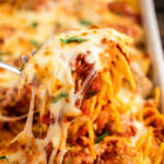 Baked spaghetti and meatballs in casserole dish.