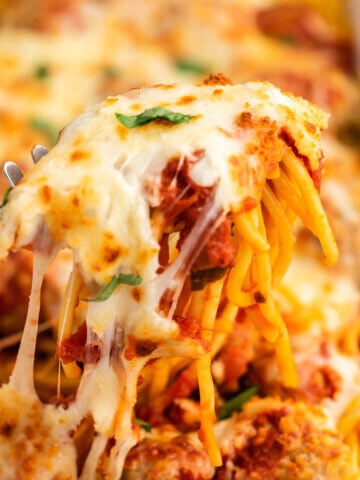 Baked spaghetti and meatballs in casserole dish.