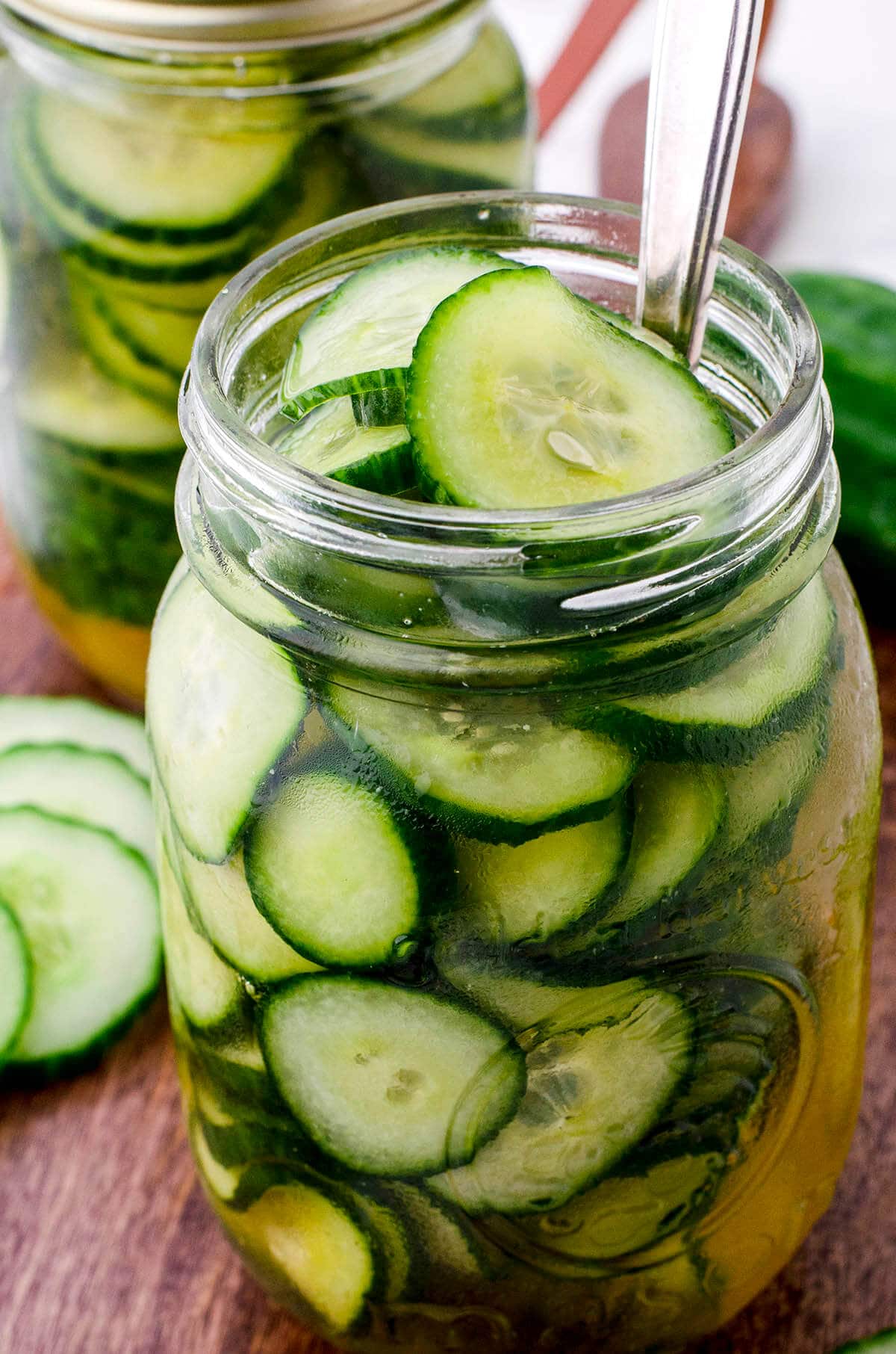 Jar of pickles on cutting board.