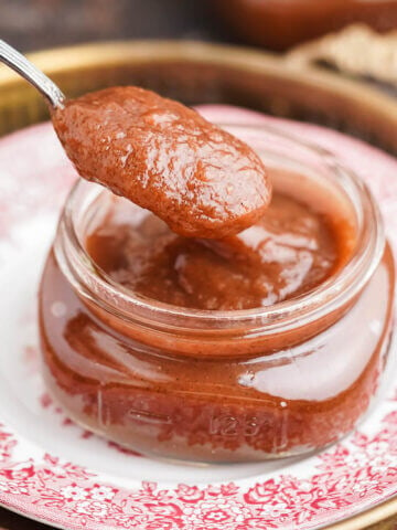Apple butter in jar with spoon.