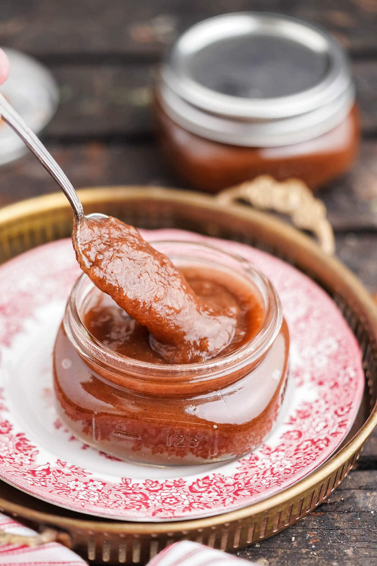 Instant Pot Apple Butter in jar with spoon.