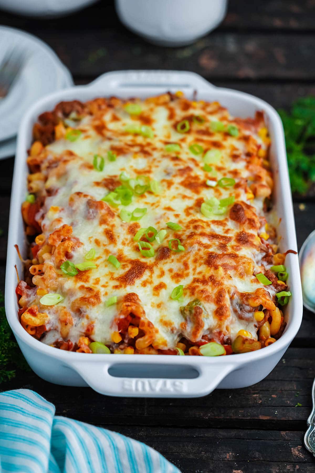 Cooked casserole in baking dish with cheesy topping.
