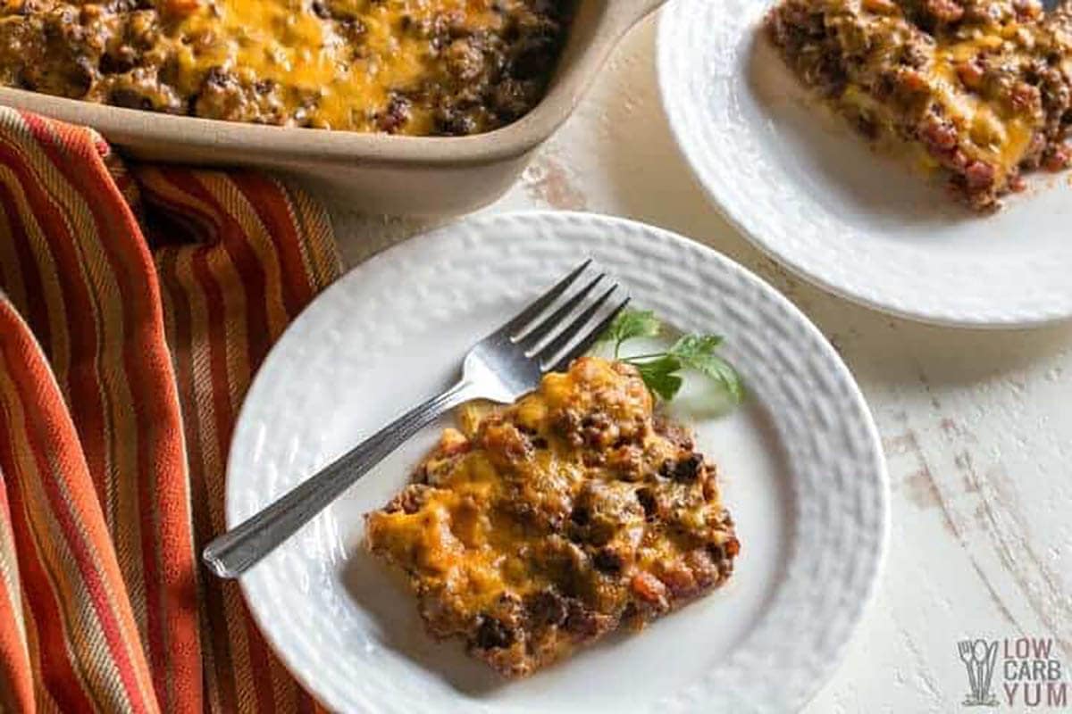 Taco casserole bake in casserole dish with a serving on a plate.