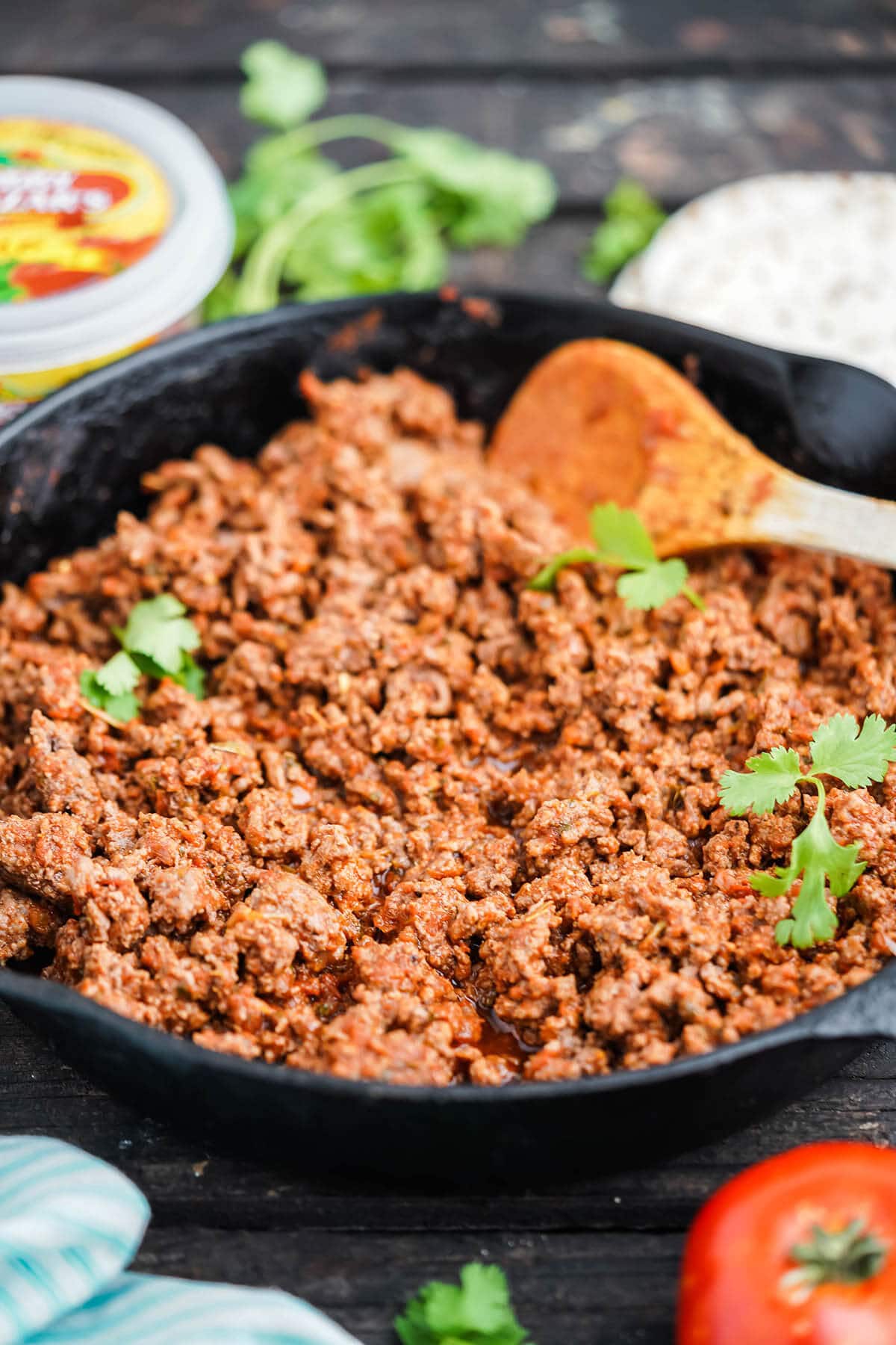 Brown ground beef in cast iron skillet seasoning with taco mix.