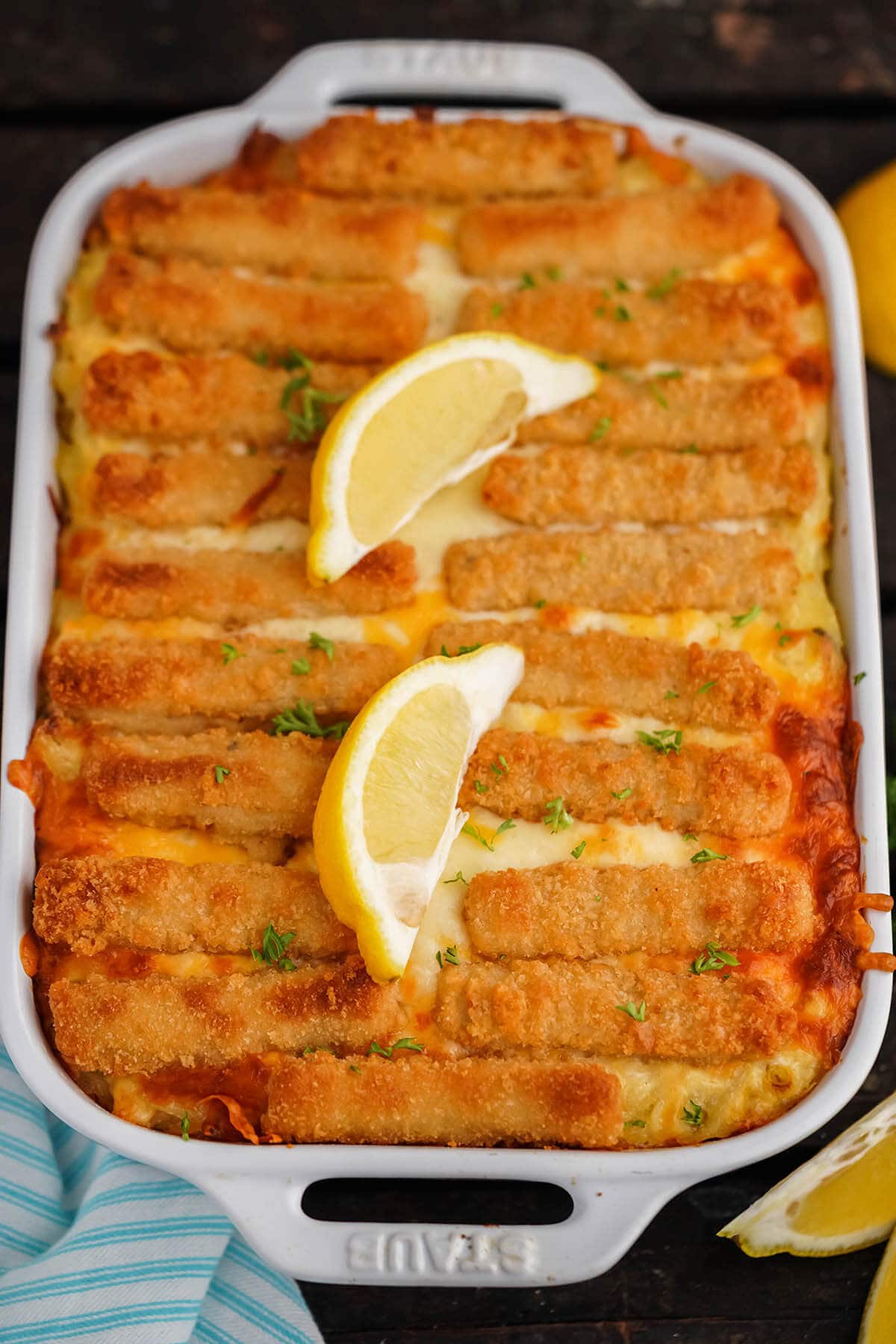 Baked cheesy casserole topped with lemon slices.