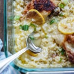 Baked chicken casserole in baking dish with serving spoon.