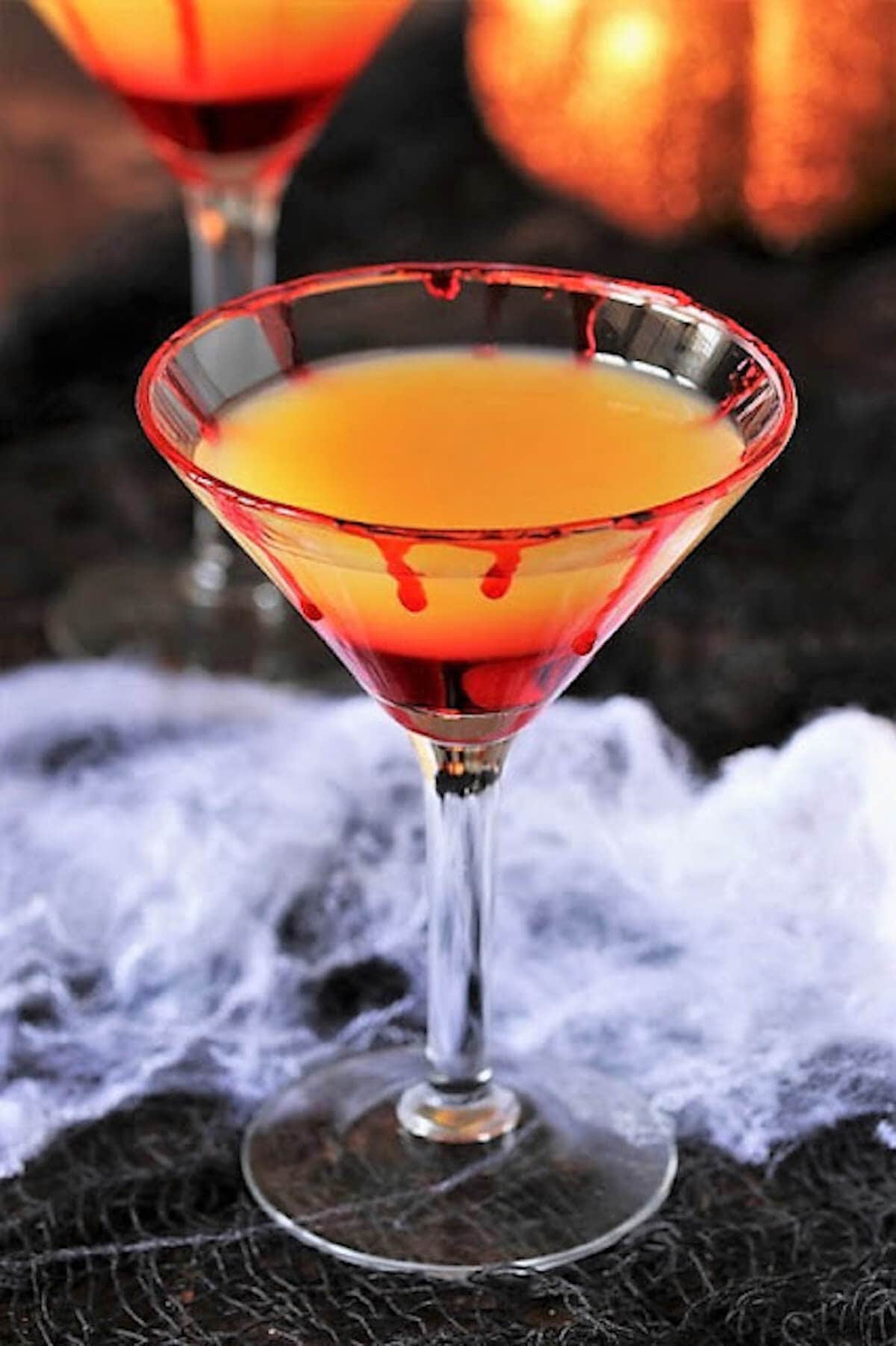 Sunrise halloween cocktail s in martini glass.