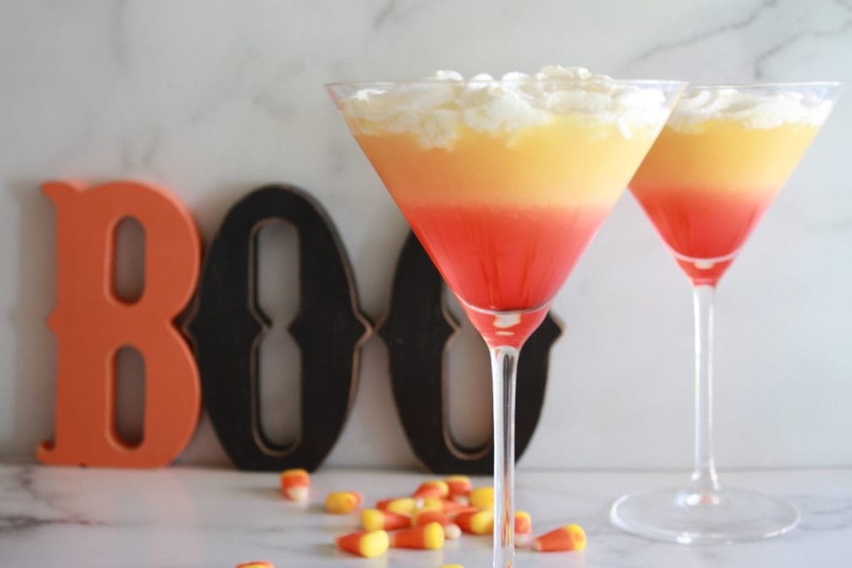 Candy corn cocktail in martini glass.