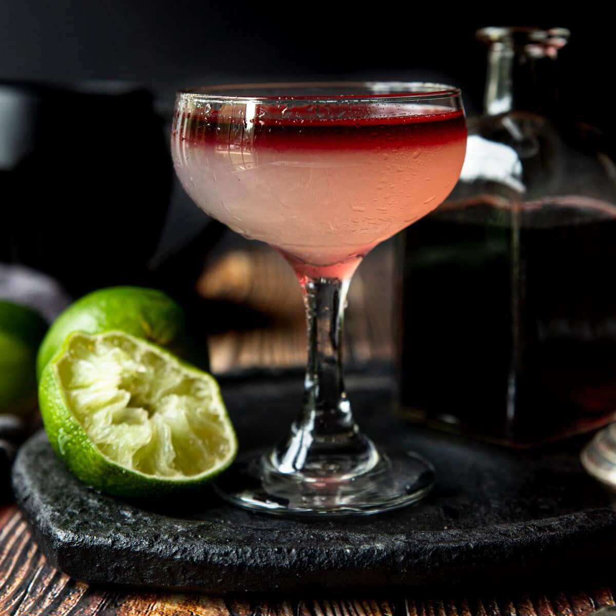 Martini in coupe glass with squeezed lime on the side.